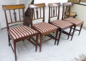 A set of four late George III Sheraton design mahogany framed dining chairs, the later fabric