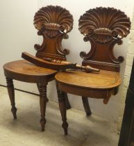 A pair of William IV mahogany hall chairs, the shell and twin C-scrolled back, over a solid seat,