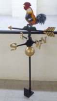 A modern painted cast iron weather vane, surmounted by a cockerel