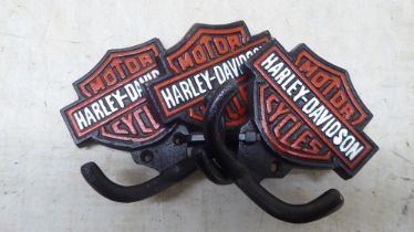 A set of three cast iron, twin handled coat hooks, branded for 'Harley Davidson'  each 4"w