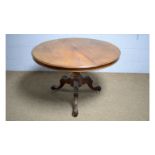 A Victorian walnut circular tilt-action breakfast table.