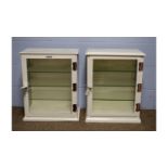 Two vintage white painted metal surgical instrument display cabinets.