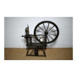 A vintage turned and ebonised spinning wheel.