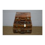 Four vintage leather suitcases, various.