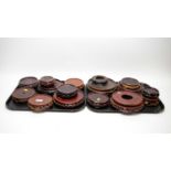 A selection of Chinese carved and stained hardwood circular stands.