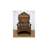 A 17th Century style oak armchair.