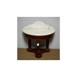 A walnut demilune marble-topped washstand.