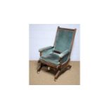An early 20th Century stained wood American style rocking chair.