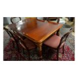 A substantial Victorian-style mahogany extending dining table.