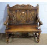 N.H. Chapman & Co. Ltd. of Newcastle: a Jacobean-style carved oak hall seat.