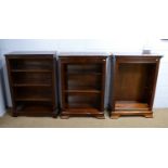 A pair of reproduction mahogany open bookcases; and another similar.