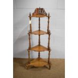A Victorian walnut graduated four-tier whatnot.