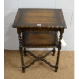 A 1920’s carved oak two-tier side table.