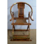 A Chinese hardwood horseshoe-back chair.