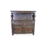 An large carved oak court cupboard.