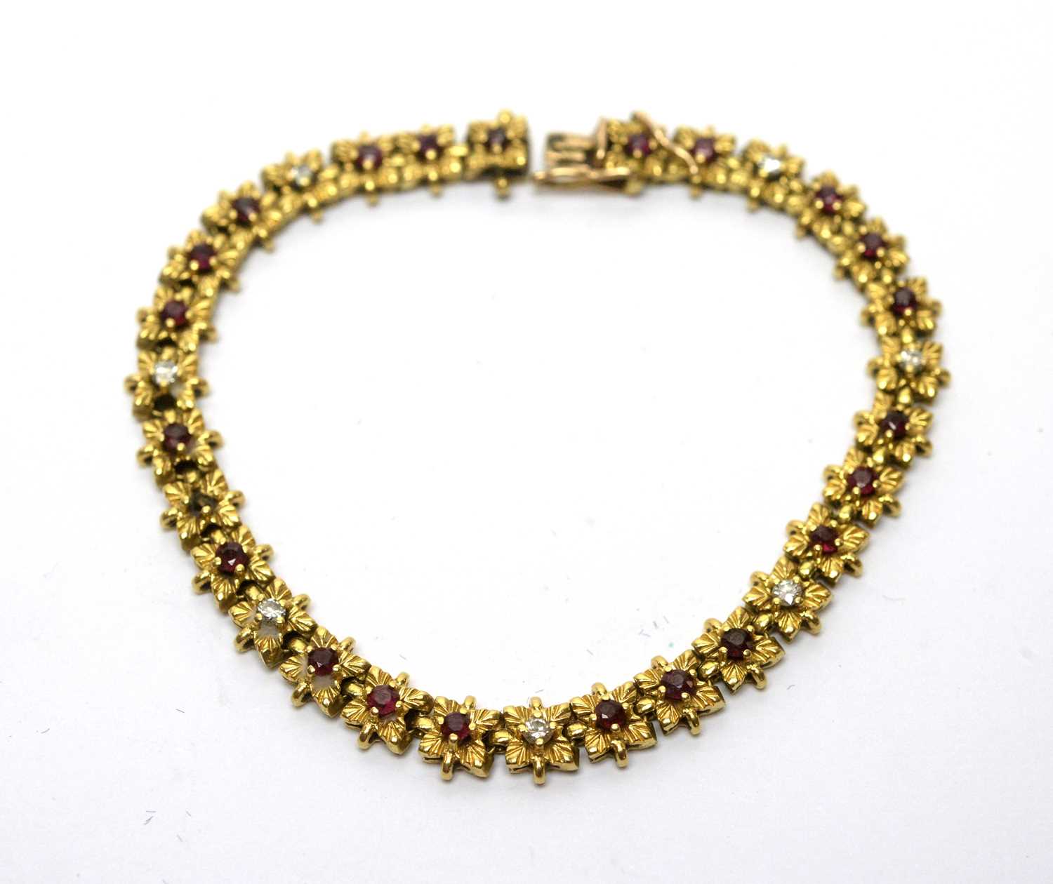 An 18ct yellow gold bracelet set with rubies and diamonds,