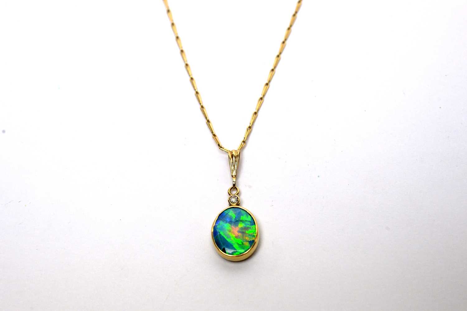 An opal and diamond pendant on chain. - Image 2 of 5