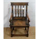 A carved oak armchair.