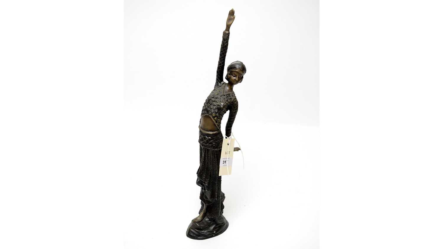 An Art Deco bronze figure of a dancer, modelled with one arm raised, 46cms high.