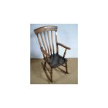 An elm and beechwood Windsor-style rocking chair.