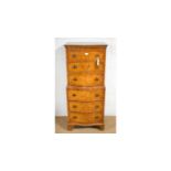 An attractive Georgian-style burr walnut serpentine front chest-on-chest.