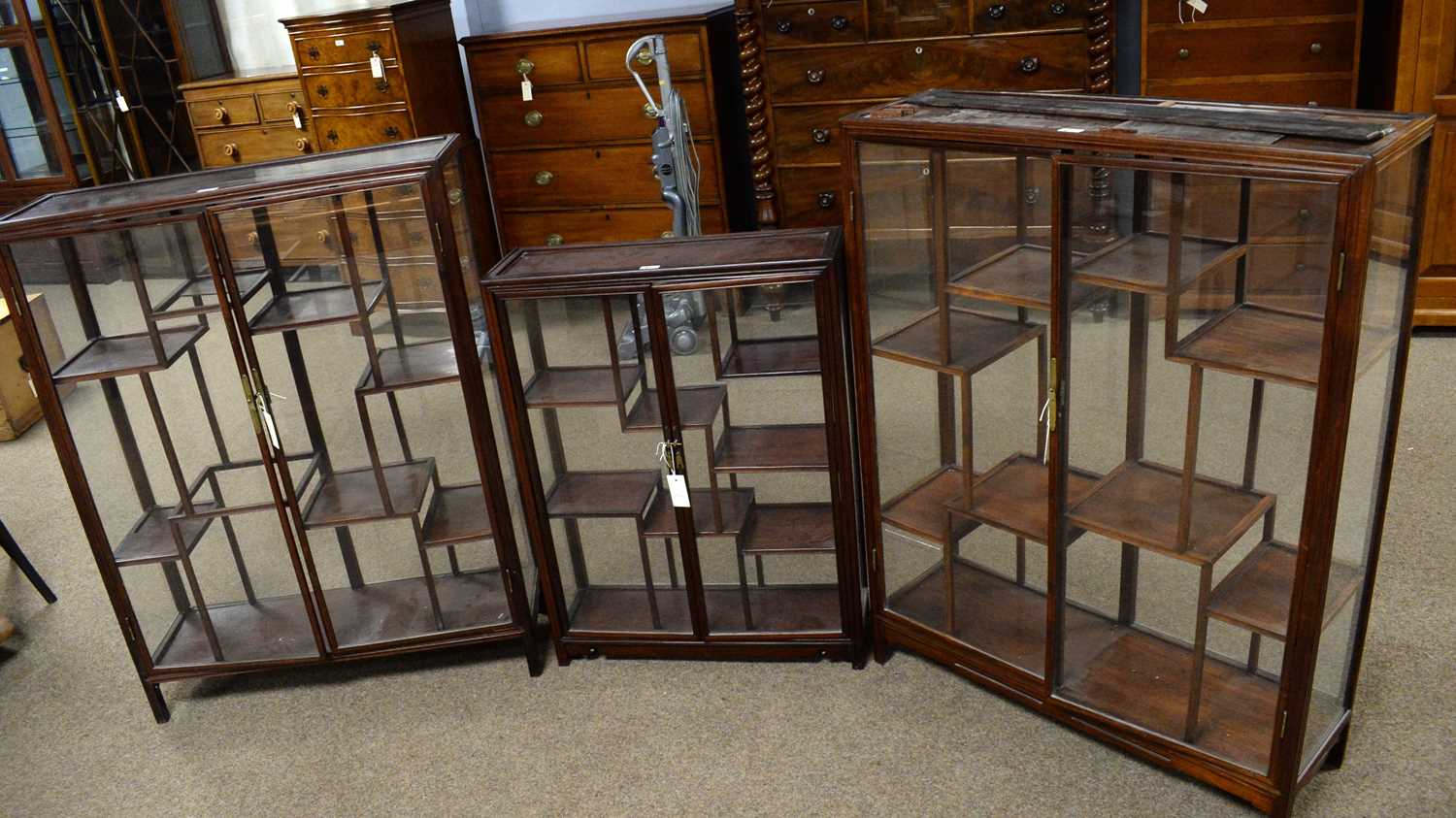 A pair and a single modern Asian hardwood display cabinet.