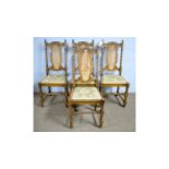 A set of four 1920's oak Jacobean-style dining chairs.