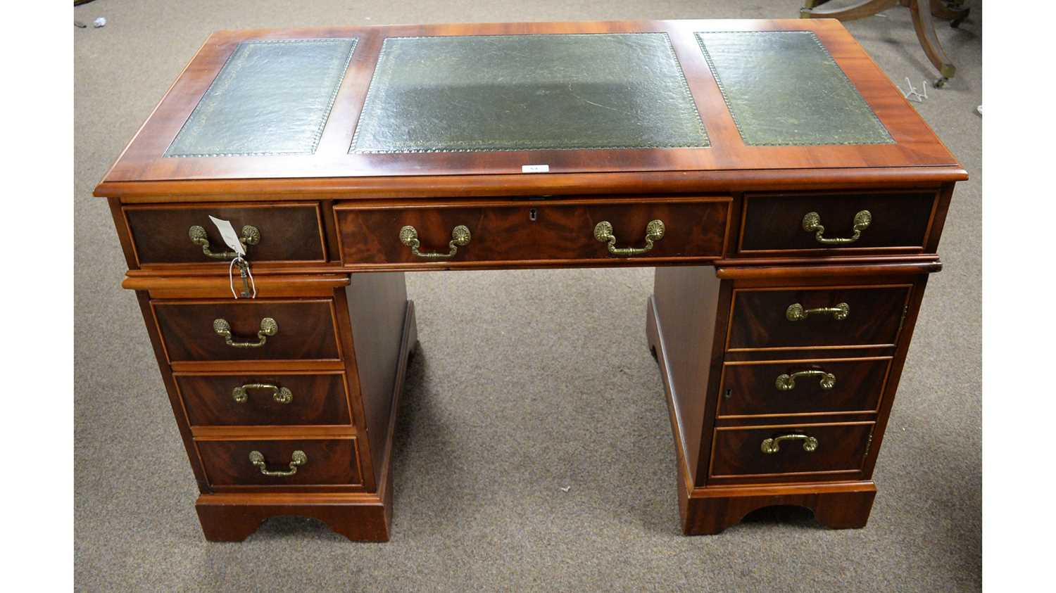 A reproduction mahogany twin-pedestal desk.