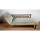 An Edwardian beechwood framed chaise longue.