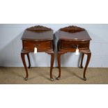 A pair of mahogany bowfront bedside tables.