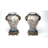 A pair of early 20th Century brass mounted twin handled vases