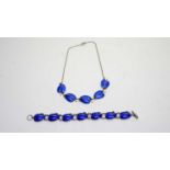 A silver and blue enamel bracelet and necklace.