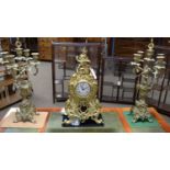 An ornate continental cast brass and Sevres style three-piece clock garniture by Lancini.