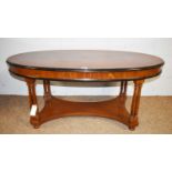 A modern oval walnut and beechwood coffee table.