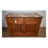 An early 20th Century walnut marble top washstand.