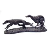 A bronzed figure group of two greyhounds.