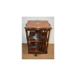 An early 20th Century inlaid mahogany revolving bookcase.