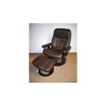 Ekornes, Norway: brown leather 'Stressless' style reclining armchair and matching stool.