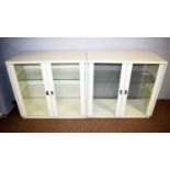 A pair of modern white-painted display cabinets.