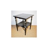 Manner of E.W.Godwin: an early 20th Century ebonised two-tier occasional table.