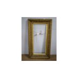 A large Victorian gilt picture frame.