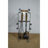 A wrought iron and beechwood handled fireside companion set and stand.