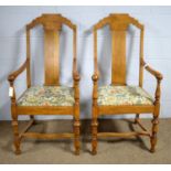 A pair of oak armchairs.