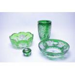 A collection of Bohemian green overlaid cut glass ware.