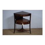 A George III mahogany and boxwood strung bowfront corner washstand.