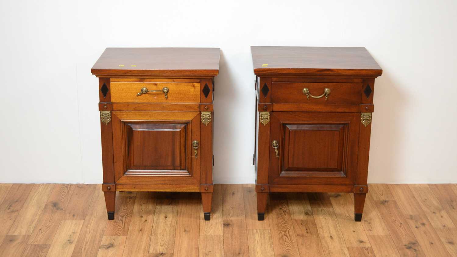 A pair of modern mahogany bedside cabinets
