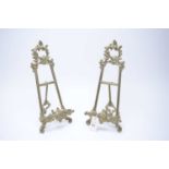 A pair of cast brass picture easels, of Rococo design.
