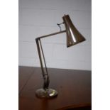 An Anglepoise desk lamp, in brown.