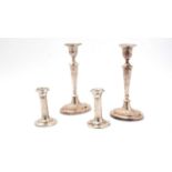 A pair of silver candlesticks, and a pair of plated candlesticks,