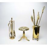 A Victorian brass four-piece fire companion set and stand.